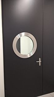 Glass frame with stainless steel ring in a security door