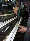 deburring the drilling hole from the railing balustrade the stainless steel surface is beeing protected against scratchmarks